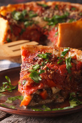 Slice of Chicago deep dish pizza on a plate macro. vertical
