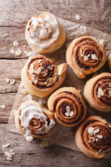 Glazed Cinnamon rolls with almond close up. vertical top view
