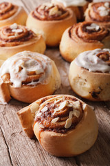 cinnamon rolls with almond close up on the table. Vertical
