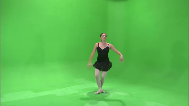Clip of a ballerina dancing en pointe on a green screen.
