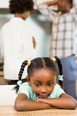 Sad girl against parents arguing