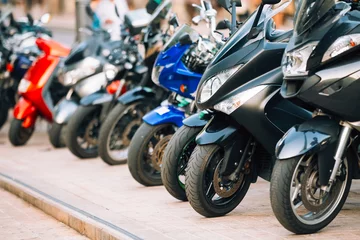 Foto op Plexiglas Motorbike, motorcycle scooters parked in row in city street © Grigory Bruev