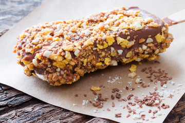 popsicle with nuts on a wooden table