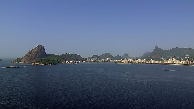 Flying above the ocean along Sugarloaf Mountain , Rio de Janeiro, Brazil