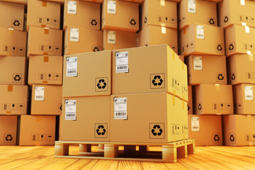 Distribution warehouse, package shipment, freight transportation and delivery concept, cardboard boxes on pallet and stack of parcels behind it on wooden floor in the retail store building