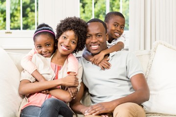 Smiling african american family sitting on the couch together