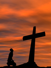 Conceptual religion cross with a man at sunset