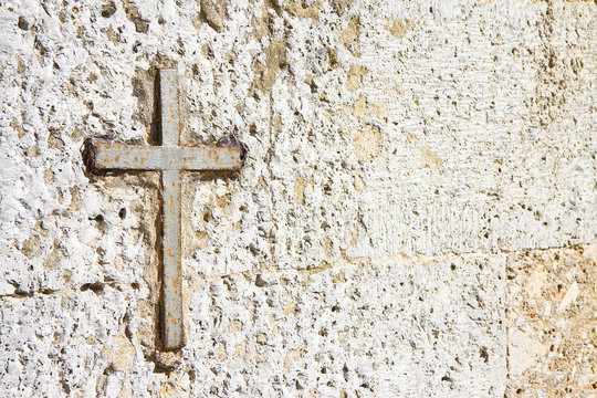 Iron cross snuggled in stone with copy space