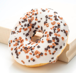 Colorful donuts on kitchen table isolated on white