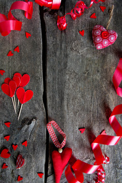 hearts and ribbons on wooden surface