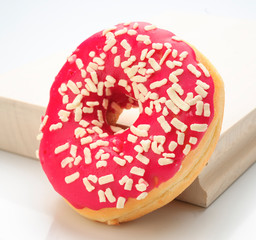 Colorful donuts on kitchen table isolated on white