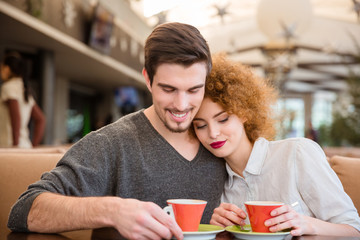Happy couple drinking coffee in restaurant
