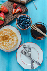 Small pancakes stack and fruits