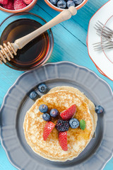 Overhead view on pancakes stack with fruit