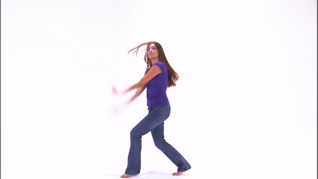 Girl in a purple shirt dancing on a white background.