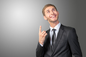 Young Businessman pointing up