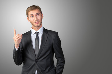 Young Businessman pointing up