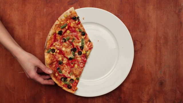 Hands taking pizza cuts. Stop motion animation, top view, 4K.