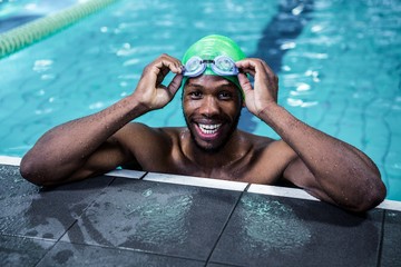 Smiling fit african american man in the swimming pool - Powered by Adobe