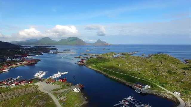 Flying above picturesque fishing town of Ballstad on Lofoten islands in Norway. Aerial 4k Ultra HD.