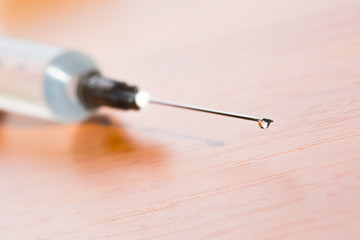 Syringe with pouring medicine close up