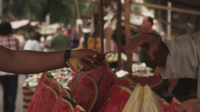 RIO DE JANEIRO, BRAZIL - JUNE 23: Buying watermelons at a market on June 23, 2013 in Rio, Brazil