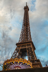 Close-up elements part of Eiffel tower in Paris against dramatic twilight sky at evening summer...