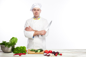 Chef posing with knife in his kitchen