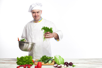Chef cooking fresh vegetable salad in his kitchen