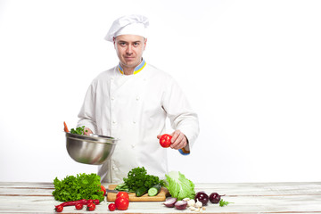 Chef cooking fresh vegetable salad in his kitchen