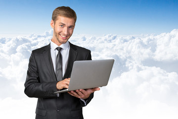 Young handsome businessman holding laptop