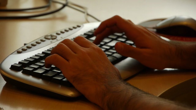 Arabic businessman uses keyboard with hairy hands