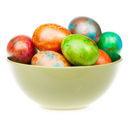 Colored easter eggs in a bowl isolated on white background