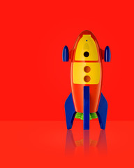 Child's Toy Rocket isolated on red background with reflection  