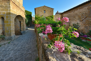 Fototapeta na wymiar Sunny narrows on a summer day in an old Italian town