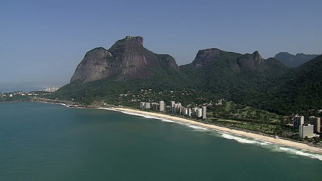 Flying along the beach to reveal Sao Conrado, Rio de Janeiro, Brazil