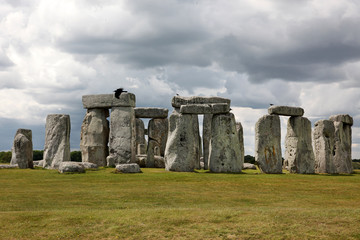 Stonehenge historic site on green grass under blue sky. Stonehen