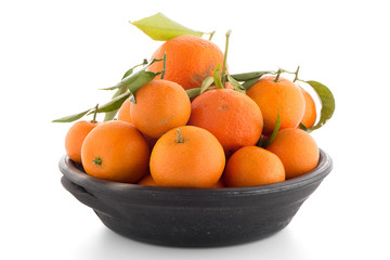 Tangerines on clay bowl