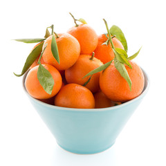 Tangerines on ceramic blue bowl