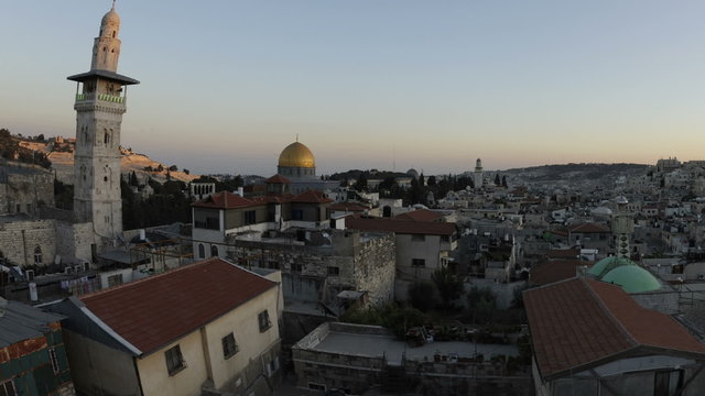 Panning shot of Tracking time-lapse of Jerusalem and the Dome of the Rock at dusk.