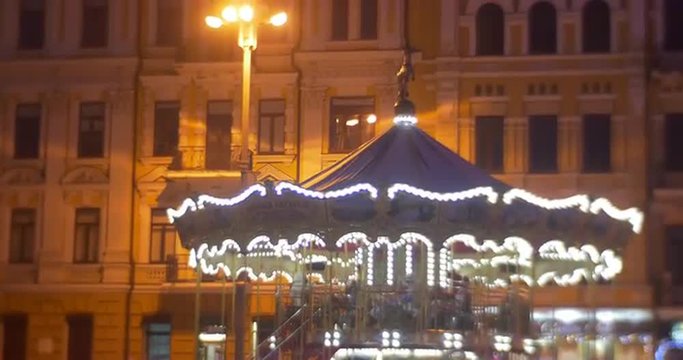 People Are Walking Around The Christmas Carousel Climbing to a Carousel Christmas Fair at Sofia Square Illuminated Street New Year's Celebration Kiev