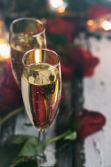Valentine: Focus On Glass Of Champage With Roses Behind