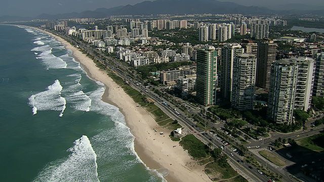 Overhead Aerial shot of Sandy Beach with Waves and City Buildings, Brazil
