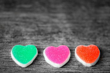 Obraz na płótnie Canvas Colorful candy sweet hearts on wooden background.- Vintage filte
