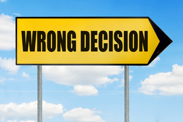 Fototapeta premium Wrong decision Sign -Yellow road sign with arrow pointing right against blue cloudy sky