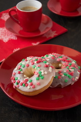 Colorful homemade donuts on red plate