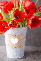 Red tulips on a wooden background.