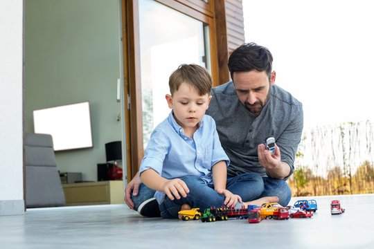 Father and son playing with cars 