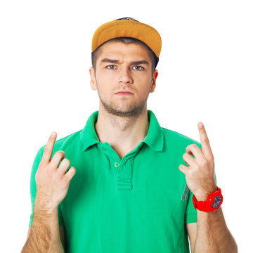 Serious young man ponting his fingers up - isolated on white.
