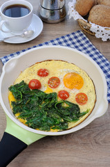 Scrambled eggs with tomato and spinach